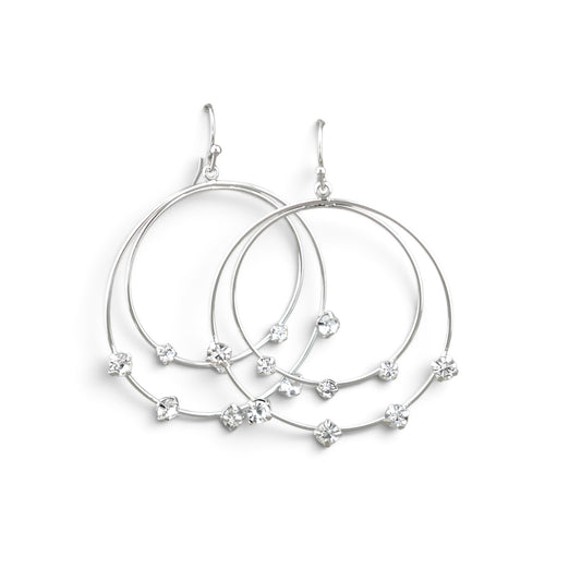 A pair of silver-toned double hoop earrings with small clear crystal flower accents, displayed on a clean white background.